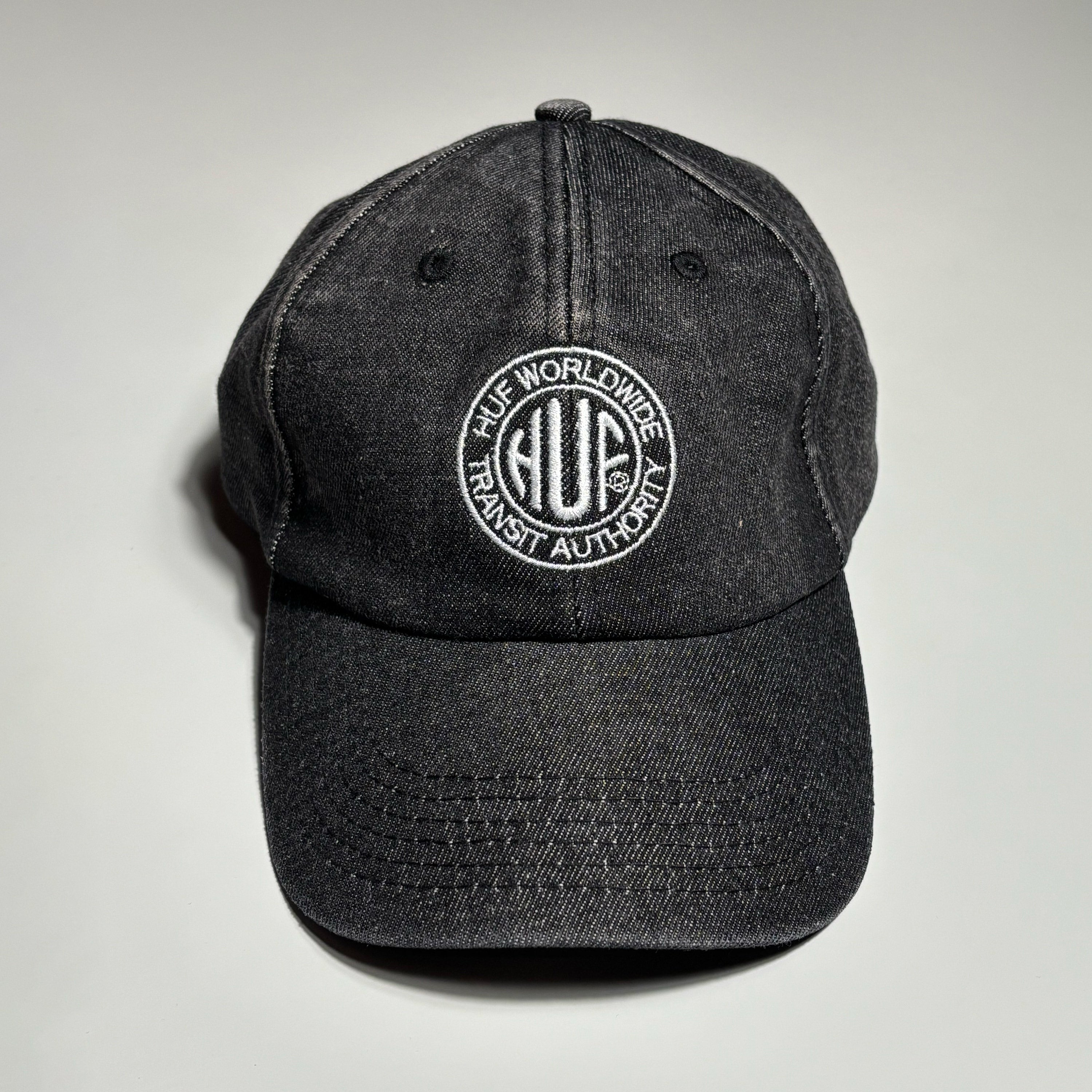 Front image of black denim hat with HUF logo embroidered on crown.